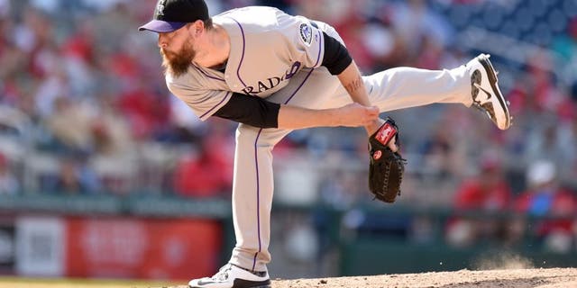 WASHINGTON, DC - AUGUST 09: John Axford #66 of the Colorado Rockies pitches in the eighth inning and get credit for the win during a baseball game against the Washington Nationals at Nationals Park on August 9, 2015 in Washington, DC. The Rockies won 6-4. (Photo by Mitchell Layton/Getty Images)
