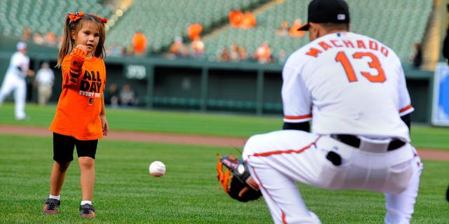 Hailey Dawson, a 5-year-old from Las Vegas, throws the ceremonial first pitch before a game between the Baltimore Orioles and Oakland Athletics on Monday, Aug. 17, 2015, at Camden Yards in Baltimore. Hailey was born with Poland Syndrome. Engineering students at the University of Nevada, Las Vegas created the "Flexy Hand 2" that she wore to throw the ball. (Lloyd Fox/Baltimore Sun/TNS via Getty Images)