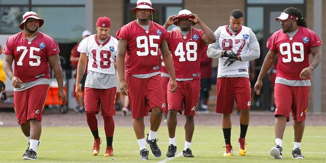 Jul 30, 2015; Richmond, VA, USA; Washington Redskins defensive end Corey Crawford (95) and Redskins defensive tackle Ricky Jean Francois (99) lead a group of teammates onto the field prior to the morning walkthrough on day one of training camp at the Washington Redskins Bon Secours Training Center. Mandatory Credit: Geoff Burke-USA TODAY Sports