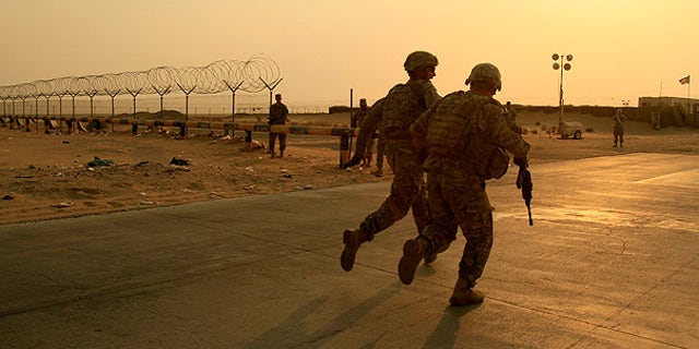 Aug. 18: U.S. Army soldiers from 2nd Battalion, 23rd Infantry Regiment, 4th Brigade, 2nd Infantry Division race toward the border from Iraq into Kuwait.