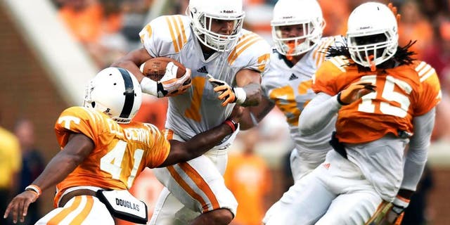 Tennessee running back Jalen Hurd (1) breaks a tackle by Tennessee defensive back Elliott Berry (41) during Tennessee's open practice at Neyland Stadium in Knoxville on Saturday, Aug. 16, 2014. (AP Photo/Knoxville News Sentinel, Adam Lau)