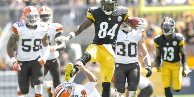 Sep 7, 2014; Pittsburgh, PA, USA; Pittsburgh Steelers wide receiver Antonio Brown (84) runs over Cleveland Browns punter Spencer Lanning (5) during the first half at Heinz Field. Brown was flagged on the play. Mandatory Credit: Jason Bridge-USA TODAY Sports