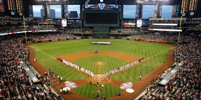 PHOENIX, AZ - APRIL 06: General view as the San Francisco Giants and the Arizona Diamondbacks stand attended for the national anthem before the Opening Day MLB game at Chase Field on April 6, 2015 in Phoenix, Arizona. (Photo by Christian Petersen/Getty Images)