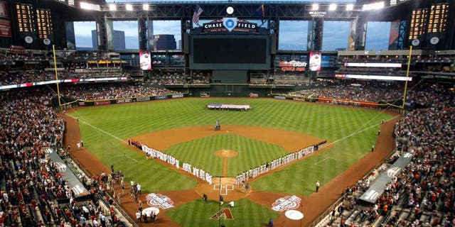 PHOENIX, AZ - APRIL 06: General view as the San Francisco Giants and the Arizona Diamondbacks stand attended for the national anthem before the Opening Day MLB game at Chase Field on April 6, 2015 in Phoenix, Arizona. (Photo by Christian Petersen/Getty Images)