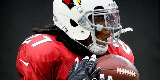 Arizona Cardinals running back Chris Johnson works out during NFL football training camp, Tuesday, Aug. 18, 2015, in Glendale, Ariz. (AP Photo/Matt York)