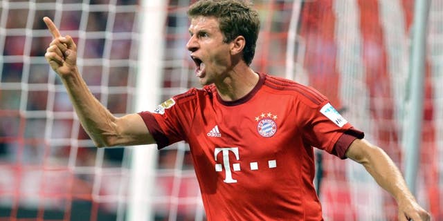MUNICH, GERMANY - AUGUST 14: Thomas Mueller of Munich celebrates after scoring a goal during the German Bundesliga soccer match between Bayern Munich and Hamburger SV at the Allianz Arena in Munich, Germany on August 14, 2015. (Photo by Joerg Koch/Anadolu Agency/Getty Images)