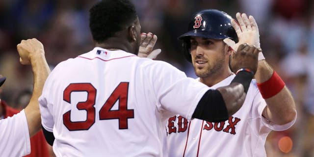 Boston Red Sox's Travis Shaw, right, is congratulated by teammate David Ortiz (34) after their back-to-back home runs off Cleveland Indians starting pitcher Corey Kluber