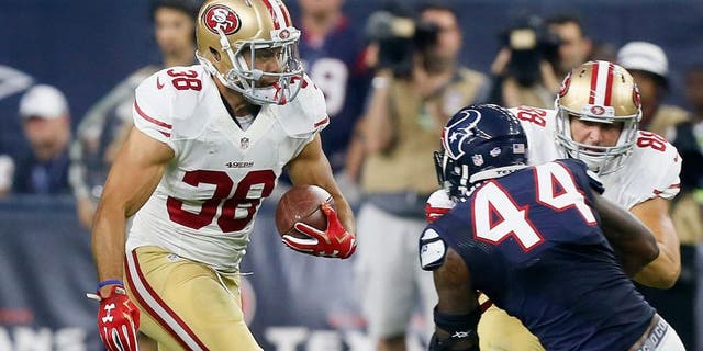 HOUSTON, TX - AUGUST 15: Jarryd Hayne #38 of the San Francisco 49ers rushes past Carlos Thompson #44 of the Houston Texans during a preseason football game at NRG Stadium on August 15, 2015 in Houston, Texas. Houston won 23-10. (Photo by Bob Levey/Getty Images)