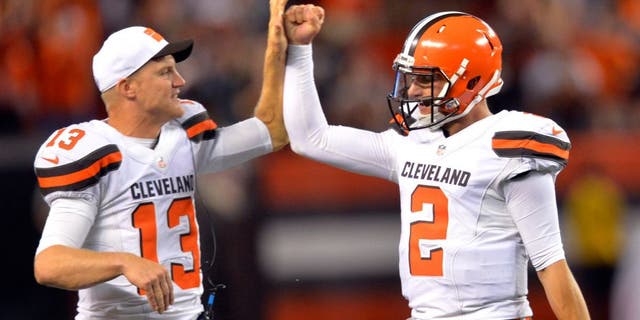 Cleveland Browns quarterback Josh McCown #13 congratulates Johnny Manziel #2 after Manziel threw a 21-yard touchdown pass to Shane Wynn during the fourth quarter of a preseason football game against the Buffalo Bills, Thursday, Aug. 20, 2015, in Cleveland.