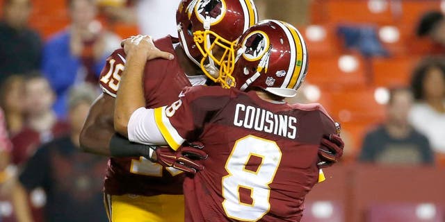 Washington Redskins wide receiver Rashad Ross (19) celebrates his touchdown with quarterback Kirk Cousins (8) during the second half of an NFL preseason football game against the Detroit Lions, Thursday, Aug. 20, 2015, in Landover, Md. (AP Photo/Alex Brandon)