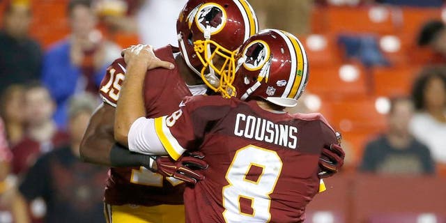 Washington Redskins wide receiver Rashad Ross (19) celebrates his touchdown with quarterback Kirk Cousins (8) during the second half of an NFL preseason football game against the Detroit Lions, Thursday, Aug. 20, 2015, in Landover, Md. (AP Photo/Alex Brandon)