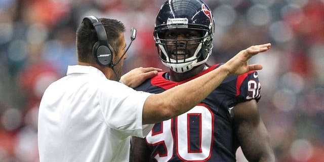 Aug 16, 2014; Houston, TX, USA; Houston Texans linebackers coach Mike Vrabel talks with linebacker Jadeveon Clowney (90) during the first quarter against the Atlanta Falcons at NRG Stadium. Mandatory Credit: Troy Taormina-USA TODAY Sports