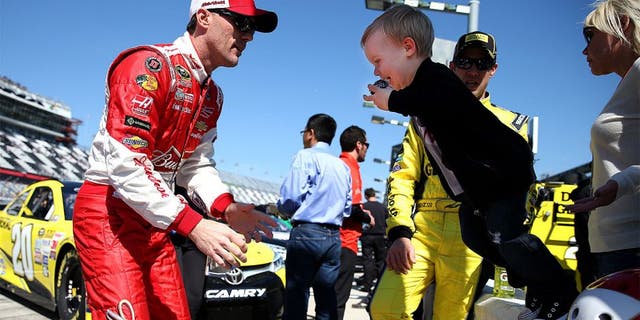 DAYTONA BEACH, FL - FEBRUARY 15: Kevin Harvick, driver of the #4 Budweiser/Jimmy John's Chevrolet, and his son Keelan during qualifying for the 57th Annual Daytona 500 at Daytona International Speedway on February 15, 2015 in Daytona Beach, Florida. (Photo by Patrick Smith/NASCAR via Getty Images)