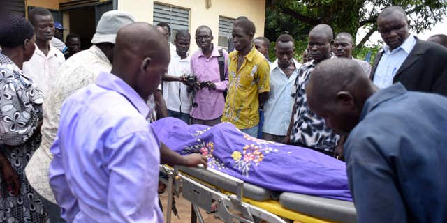 Aug. 20, 2015: Relatives and other mourners watch as the body of South Sudanese journalist Peter Julius Moi is taken into the mortuary in Juba, South Sudan.