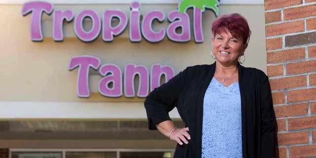 June 17, 2016: Kim Arnold stands for a photo outside her Tropical Tann business in Queensbury, N.Y.