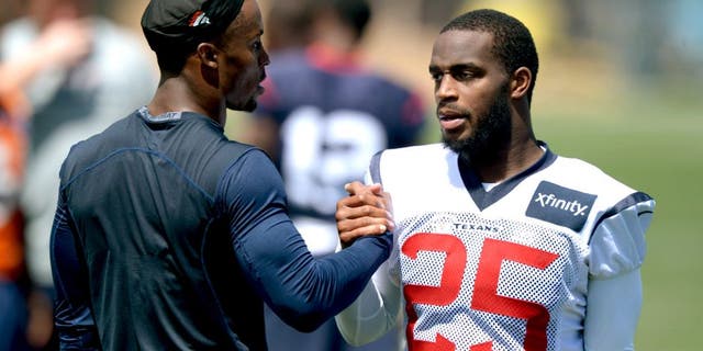 Aug 19, 2014; Englewood, CO, USA; Houston Texans cornerback Kareem Jackson (25) shakes hands with Denver Broncos safety Rahim Moore during scrimmage at the Broncos Headquarters. Mandatory Credit: Kirby Lee-USA TODAY Sports