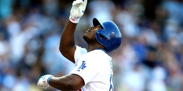 LOS ANGELES, CA - AUGUST 15: Yasiel Puig #66 of the Los Angeles Dodgers celebrates as he crosses home plate after hitting a solo home run in the second inning against the Cincinnati Reds at Dodger Stadium on August 15, 2015 in Los Angeles, California. (Photo by Stephen Dunn/Getty Images)