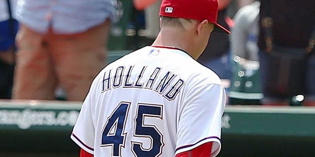 ARLINGTON, TX - AUGUST 19: Fans cheer as Derek Holland #45 of the Texas Rangers leaves the mound after pitching in the seventh inning during a game against the Seattle Mariners at Globe Life Park in Arlington on August 19, 2015 in Arlington, Texas. The Texas Rangers defeated the Seattle Mariners 7-2. (Photo by Sarah Crabill/Getty Images)