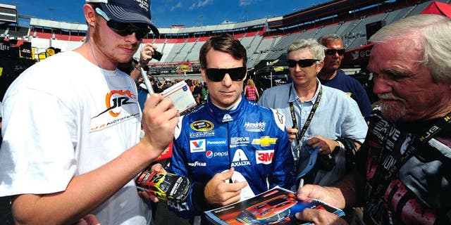 BRISTOL, TN - AUGUST 21: Jeff Gordon, driver of the #24 Axalta Chevrolet, signs autographs during practice for the NASCAR Sprint Cup Series Irwin Tools Night Race at Bristol Motor Speedway on August 21, 2015 in Bristol, Tennessee. (Photo by Jeff Curry/NASCAR via Getty Images)