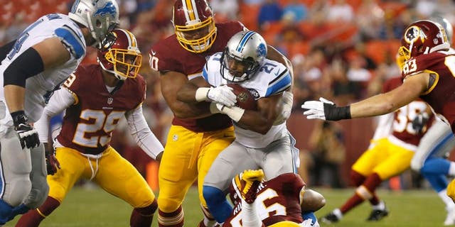 Aug 20, 2015; Landover, MD, USA; Detroit Lions running back Ameer Abdullah (21) carries the ball as Washington Redskins inside linebacker Perry Riley (56) and Redskins defensive tackle Stephen Paea (90) make the tackle in the first quarter at FedEx Field. Mandatory Credit: Geoff Burke-USA TODAY Sports