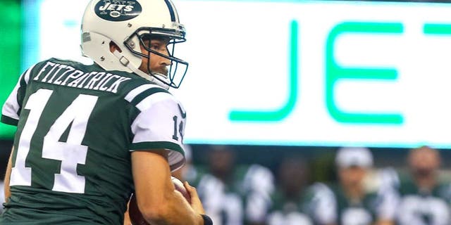 Aug 21, 2015; East Rutherford, NJ, USA; New York Jets quarterback Ryan Fitzpatrick (14) runs with the ball during the first half at MetLife Stadium. Mandatory Credit: Ed Mulholland-USA TODAY Sports