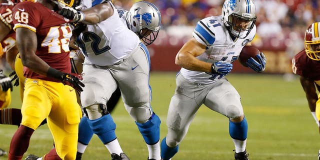 Aug 20, 2015; Landover, MD, USA; Detroit Lions running back Zach Zenner (41) carries the ball past Washington Redskins linebacker Dyshawn Davis (48) in the third quarter at FedEx Field. The Redskins won 21-17. Mandatory Credit: Geoff Burke-USA TODAY Sports