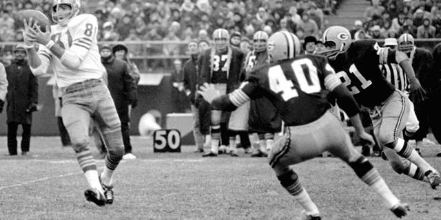 End Dave Parks of the San Francisco 49ers (81) catches a pass from quarterback John Brodie for an 11-yard gain in the second period of NFL game at County Stadium on Sunday, Dec. 4, 1966. Tom Brown (40) and Bob Jeter (21) of the Green Bay Packers poise for the tackle. (AP Photo)