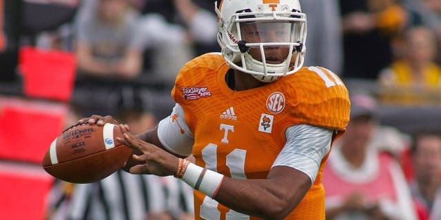 Jan 2, 2015; Jacksonville, FL, USA; Tennessee Volunteers quarterback Joshua Dobbs (11) looks for a receiver in the first quarter of the 2015 TaxSlayer Bowl against the Iowa Hawkeyes at EverBank Field. The Tennessee Volunteers beat the Iowa Hawkeyes 45-28. Mandatory Credit: Phil Sears-USA TODAY Sports