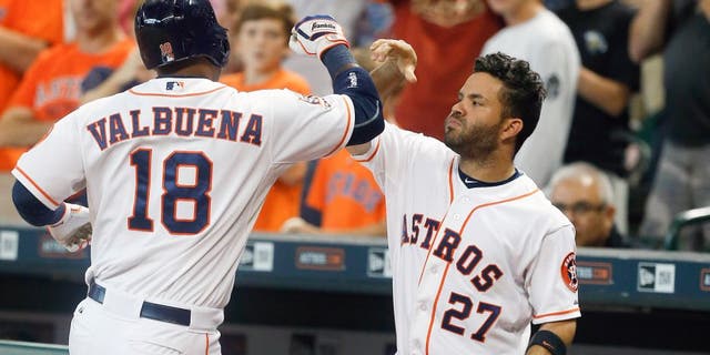 HOUSTON, TX - AUGUST 22: Luis Valbuena #18 of the Houston Astros celebrates with Jose Altuve #27 afer hitting a home run in the second inning against the Los Angeles Dodgers at Minute Maid Park on August 22, 2015 in Houston, Texas. (Photo by Bob Levey/Getty Images)
