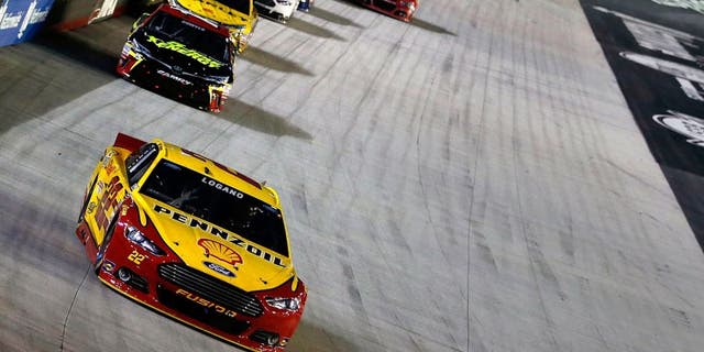 BRISTOL, TN - AUGUST 22: Joey Logano, driver of the #22 Shell Pennzoil Ford, leads a pack of cars during the NASCAR Sprint Cup Series IRWIN Tools Night Race at Bristol Motor Speedway on August 22, 2015 in Bristol, Tennessee. (Photo by Gregory Shamus/Getty Images)