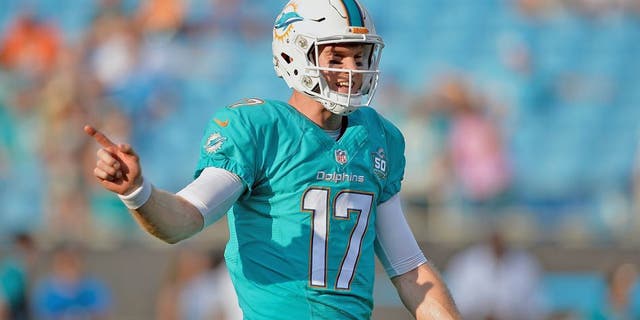 CHARLOTTE, NC - AUGUST 22: Ryan Tannehill #17 of the Miami Dolphins directs his teammates during their preseason NFL game against the Carolina Panthers at Bank of America Stadium on August 22, 2015 in Charlotte, North Carolina. (Photo by Grant Halverson/Getty Images)