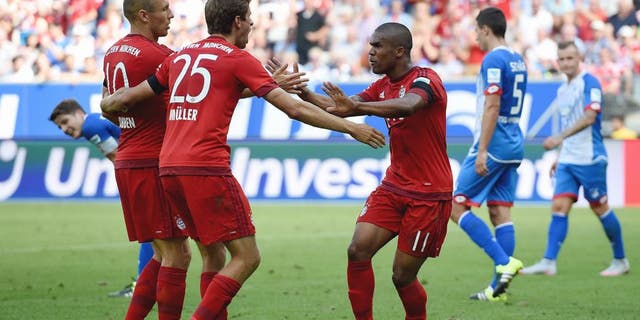 SINSHEIM, GERMANY - AUGUST 22: Thomas Mueller of Muenchen celebrates with his team-mates after scoring his team's first goal during the Bundesliga match between 1899 Hoffenheim and FC Bayern Muenchen at Wirsol Rhein-Neckar-Arena on August 22, 2015 in Sinsheim, Germany. (Photo by Matthias Hangst/Bongarts/Getty Images)