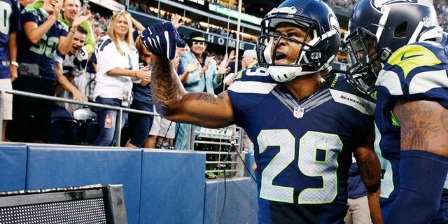 Aug 22, 2014; Seattle, WA, USA; Seattle Seahawks free safety Earl Thomas (29) celebrates after a 59-yard punt return against the Chicago Bears during the second quarter at CenturyLink Field. Seattle Seahawks strong safety Jeron Johnson (23) is at right. Mandatory Credit: Joe Nicholson-USA TODAY Sports