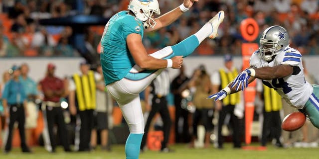 Aug 23, 2014; Miami Gardens, FL, USA; Dallas Cowboys outside linebacker Bruce Carter (54) blocks the punt of Miami Dolphins punter Brandon Fields (2) during the first half at Sun Life Stadium. Mandatory Credit: Steve Mitchell-USA TODAY Sports
