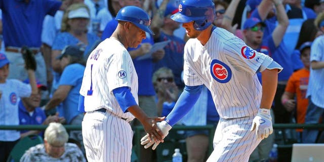 Aug 23, 2015; Chicago, IL, USA; Chicago Cubs third baseman Kris Bryant (17) is congratulated for hitting a home run by third base coach Gary Jones (1) during the sixth inning against the Atlanta Braves at Wrigley Field. Mandatory Credit: Dennis Wierzbicki-USA TODAY Sports