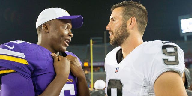 Aug 22, 2015; Minneapolis, MN, USA; Minnesota Vikings quarterback Teddy Bridgewater (5) and Oakland Raiders quarterback Christian Ponder (9) talk after the game at TCF Bank Stadium. The Minnesota Vikings beat the Oakland Raiders 20-12. Mandatory Credit: Brad Rempel-USA TODAY Sports