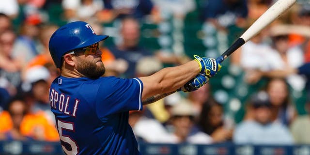 Aug 23, 2015; Detroit, MI, USA; Texas Rangers designated hitter Mike Napoli (25) hits a home run in the eighth inning against the Detroit Tigers at Comerica Park. Mandatory Credit: Rick Osentoski-USA TODAY Sports