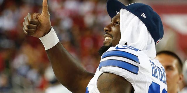 Dallas Cowboys wide receiver Dez Bryant gestures to fans during the second half of an NFL preseason football game against the San Francisco 49ers in Santa Clara, Calif., Sunday, Aug. 23, 2015. (AP Photo/Tony Avelar)