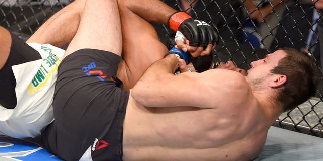 SASKATOON, SK - AUGUST 23: (R-L) Nikita Krylov of Ukraine secures a rear choke submission against Marcos Rogerio de Lima of Brazil in their light heavyweight bout during the UFC event at the SaskTel Centre on August 23, 2015 in Saskatoon, Saskatchewan, Canada. (Photo by Jeff Bottari/Zuffa LLC/Zuffa LLC via Getty Images)