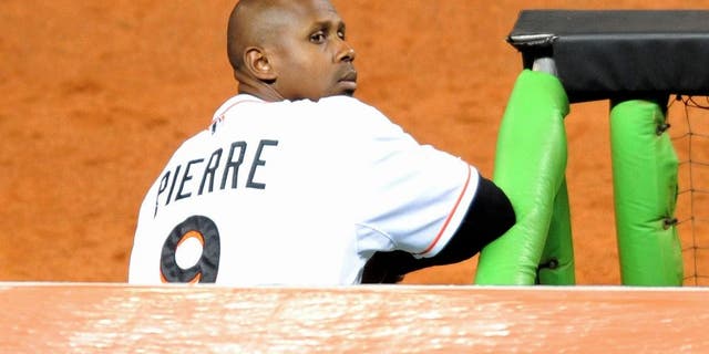 Sep 9, 2013; Miami, FL, USA; Miami Marlins left fielder Juan Pierre (9) looks on from the dugout during the third inning against the Atlanta Braves at Marlins Park. Mandatory Credit: Steve Mitchell-USA TODAY Sports