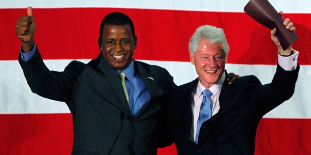 Aug. 16: Rep. Kendrick Meek and Former President Bill Clinton wave as they are introduced during a rally in Davie, Fla.