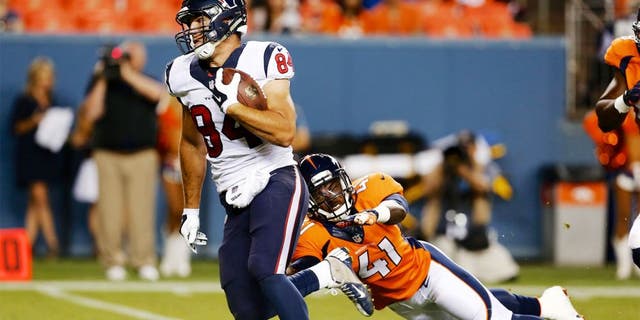 Aug 23, 2014; Denver, CO, USA; Houston Texans tight end Ryan Griffin (84) avoids the tackle of Denver Broncos defensive back Charles Mitchell (41) to run for a touchdown in the fourth quarter at Sports Authority Field at Mile High. The Texans defeated the Broncos 18-17. Mandatory Credit: Isaiah J. Downing-USA TODAY Sports