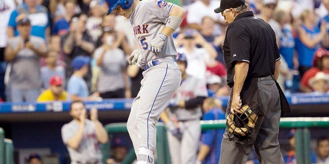Aug 24, 2015; Philadelphia, PA, USA; New York Mets third baseman David Wright (5) jumps on home plate after hitting a solo home run during the second inning against the Philadelphia Phillies at Citizens Bank Park. Mandatory Credit: Bill Streicher-USA TODAY Sports