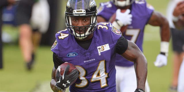 Jul 30, 2015; Owings Mills, MD, USA; Baltimore Ravens running back Lorenzo Taliaferro (34) carries the ball during drills on day one of training camp at Under Armour Performance Center. Mandatory Credit: Tommy Gilligan-USA TODAY Sports