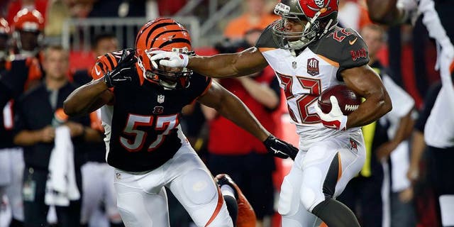 Aug 24, 2015; Tampa, FL, USA; Tampa Bay Buccaneers running back Doug Martin (22) runs with the ball as Cincinnati Bengals outside linebacker Vincent Rey (57) attempted to defend during the first quarter at Raymond James Stadium. Mandatory Credit: Kim Klement-USA TODAY Sports