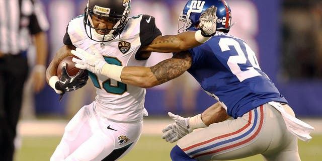 Aug 22, 2015; East Rutherford, NJ, USA; Jacksonville Jaguars wide receiver Rashad Greene (13) catches a ball in front of New York Giants safety Bennett Jackson (24) during the first half at MetLife Stadium. Mandatory Credit: Danny Wild-USA TODAY Sports