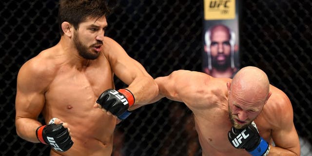 SASKATOON, SK - AUGUST 23: (L-R) Patrick Cote punches Josh Burkman of the United States in their welterweight bout during the UFC event at the SaskTel Centre on August 23, 2015 in Saskatoon, Saskatchewan, Canada. (Photo by Jeff Bottari/Zuffa LLC/Zuffa LLC via Getty Images)