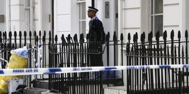 Aug. 25: A British Community Police Support Officer stands quard outside a house in central London, near the headquarters of MI6, where a man believed to be a British spy has been found dead in a flat.