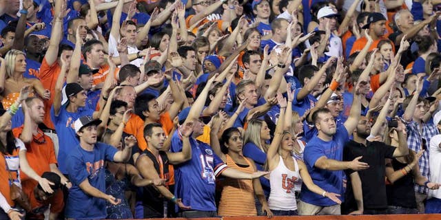 October 1, 2011; Gainesville FL, USA; Florida Gators fans do the gator chomp and cheer during the first quarter against the Alabama Crimson Tide at Ben Hill Griffin Stadium. Mandatory Credit: Kim Klement-USA TODAY Sports