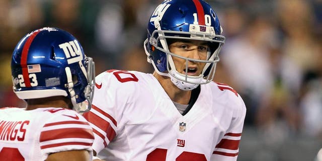 Aug 22, 2014; East Rutherford, NJ, USA; New York Giants quarterback Eli Manning (10) directs running back Rashad Jennings (23) against the New York Jets during the first quarter at MetLife Stadium. Mandatory Credit: Adam Hunger-USA TODAY Sports